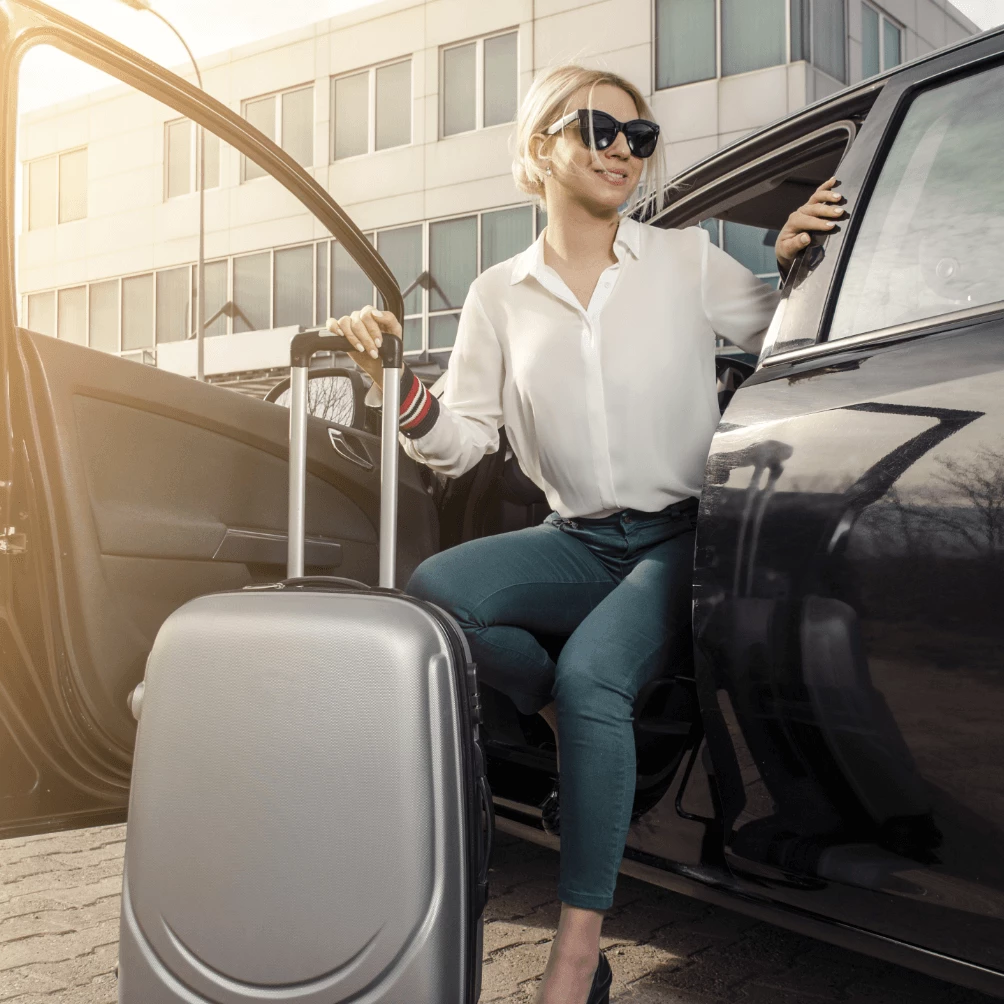 Woman getting out of her car with a trolley