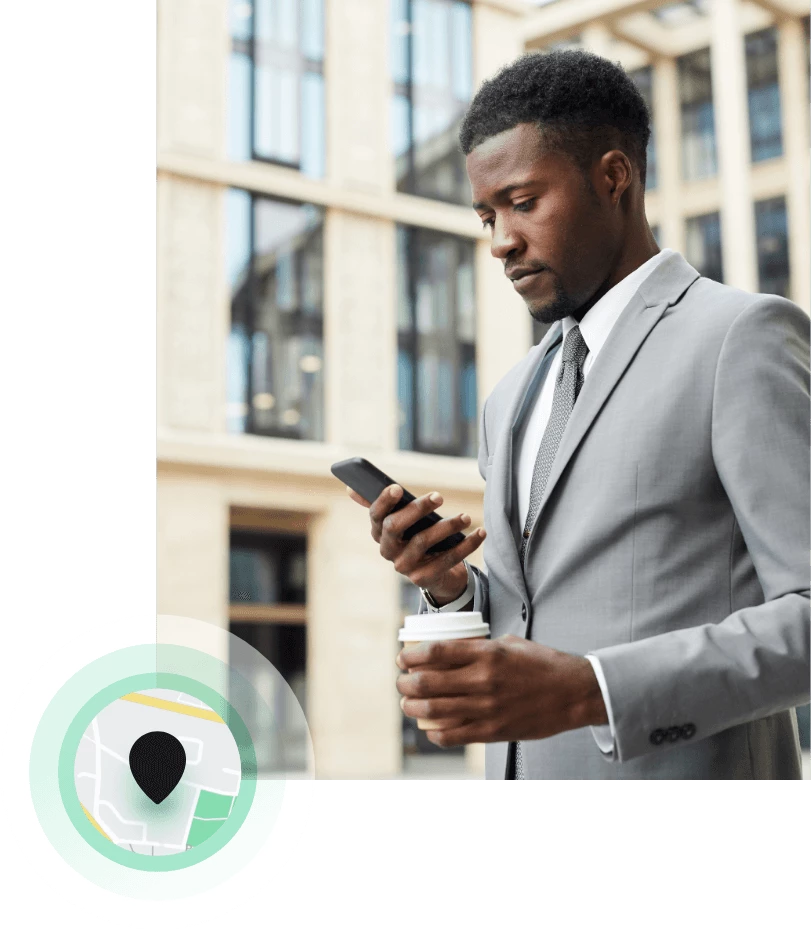 Man using the YourParkingSpace App while holding a coffee