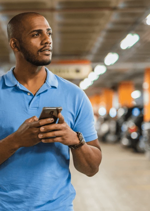 Man using the YourParkingSpace app on his phone