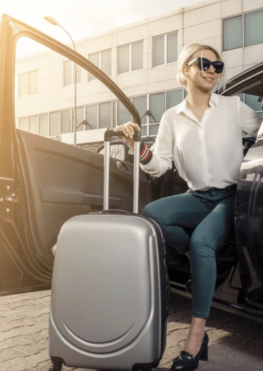 Woman getting out of her car with a trolley