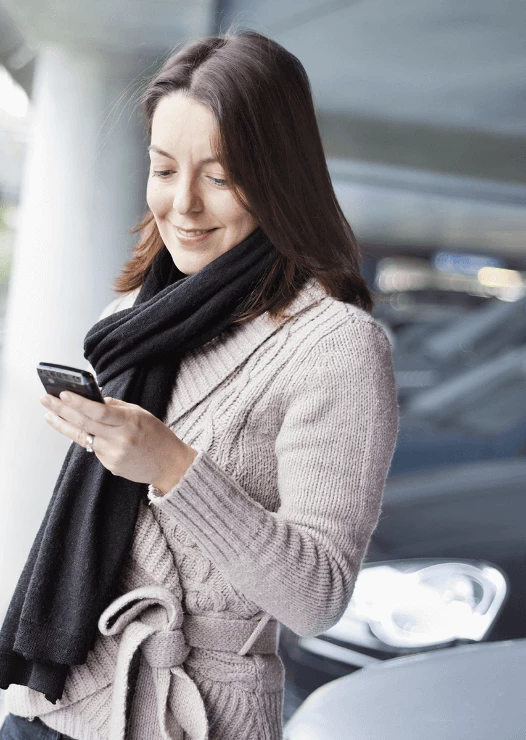 Woman using the YourParkingSpace App on her phone