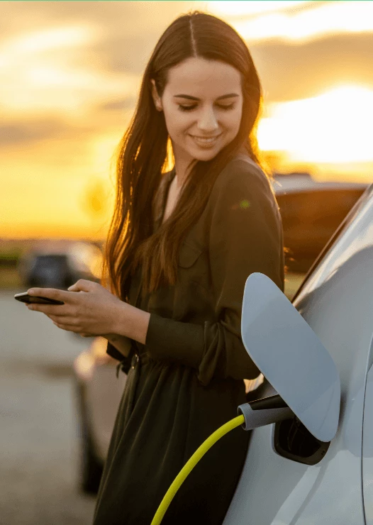 Woman smiling and charging her car